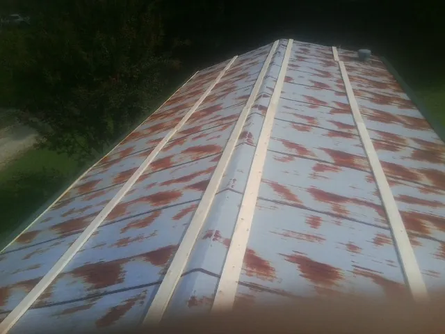 Rusted metal roof panels with new wood purlins before replacement — Storm Damage Roof Repair in Bechtelsville by Roofing Brothers
