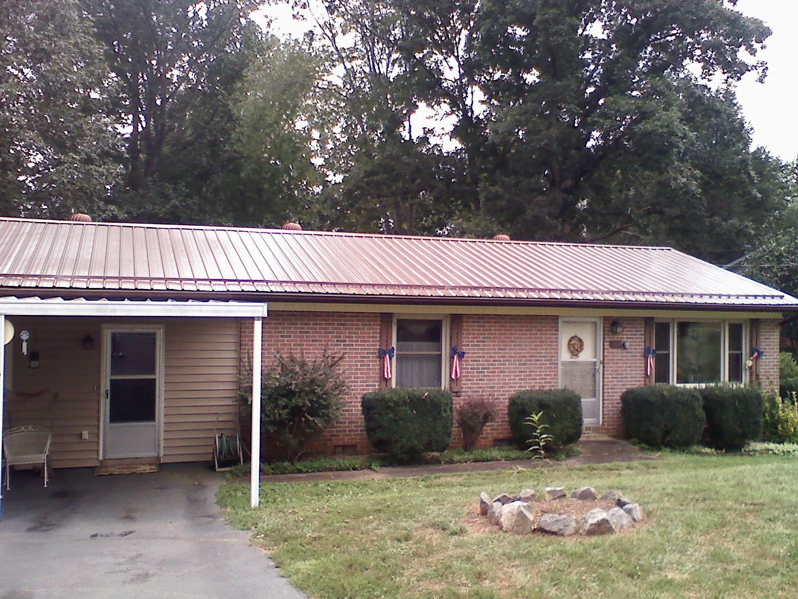 Bronze metal roof and carport on a brick ranch home — Roof Repair work by our crew in Bechtelsville